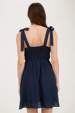 Load image into Gallery viewer, girl wearing navy mini dress facing back