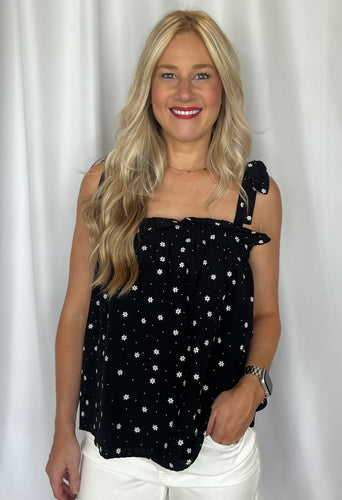 blonde girl wearing black daisy tank top
