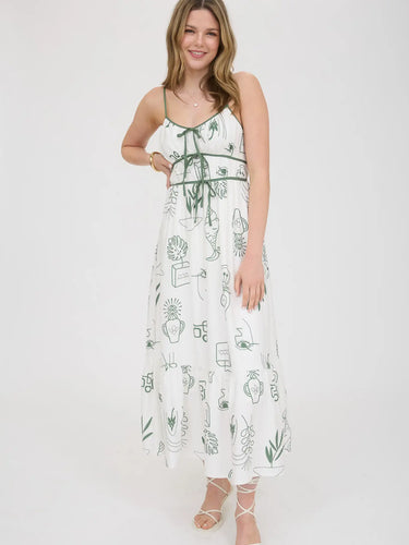 Woman wearing white dress with green straps