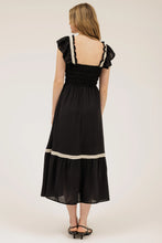 Load image into Gallery viewer, Girl wearing ruffle dress facing backwards 

