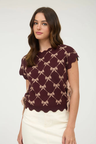Girl wearing scallop bow sweater 