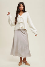 Load image into Gallery viewer, Girl wearing off white bow sweater 
